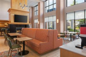 a lobby with a couch and a fireplace at Hampton Inn & Suites by Hilton Langley-Surrey in Surrey