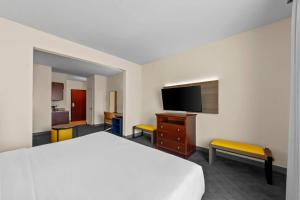 a hotel room with a bed and a flat screen tv at Comfort Suites San Antonio North - Stone Oak in San Antonio