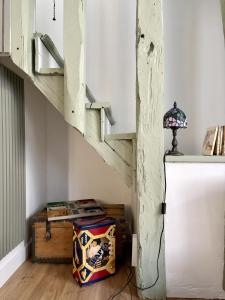 a room with a refrigerator and a stair case at L'Escapade Maillotine in Joigny