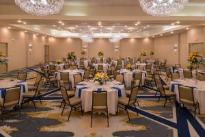 a banquet hall with tables and chairs and chandeliers at Radisson Hotel St Louis Downtown Convention Center in Saint Louis +102 photos