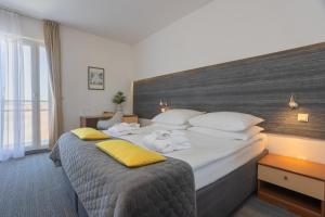 a hotel room with a large bed with towels on it at Hotel Punta in Vodice +38 photos