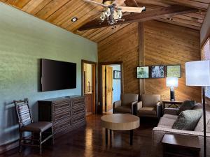 a living room with a couch and a tv at Hilton Grand Vacations Club Stonewater Cove Shell Knob in Shell Knob