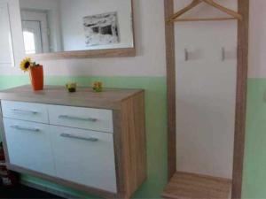 a room with a dresser with a mirror and a dresser at Ferienhaus Ostsee Antje Bellmann in Kemnitz