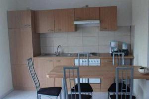 a kitchen with a wooden counter top and chairs at Ferienhaus Ostsee Antje Bellmann in Kemnitz