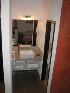 a bathroom with a sink and a mirror at Finca El Amparo in Los Reartes