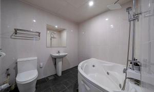 a white bathroom with a toilet and a sink at 충주 호텔 발리 in Chungju +14 photos