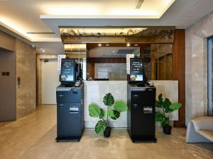 a lobby with two atm machines in a room at Guide Hotel Taipei NTU in Taipei +113 photos