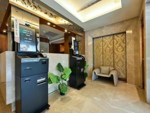 a lobby with a computer and a chair at Guide Hotel Taipei NTU in Taipei