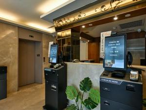a lobby with a desk with a computer on it at Guide Hotel Taipei NTU in Taipei