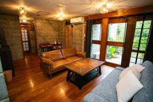 a living room with a couch and a table at 香琉 Kaoru in Miyako-jima
