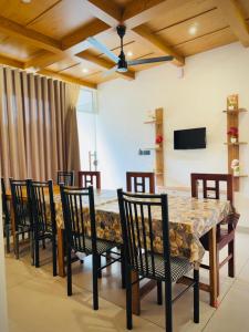 a dining room with a large table and chairs at River Side Paradise By Greenleaves Munnar in Anachal
