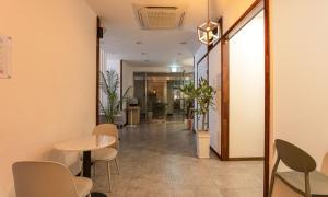 a corridor of a office with a table and chairs at Anyang CNC Hotel in Anyang