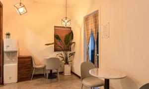 a room with chairs and a table and a window at Anyang CNC Hotel in Anyang