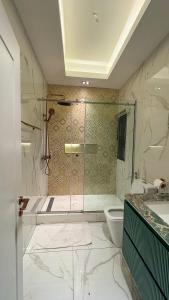 a bathroom with a shower and a toilet at Mac Residence in Lagos +91 photos