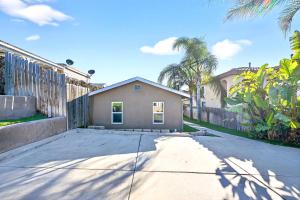 a house on a street with a fence at San Diego 3BR & 3BA Comfortable Home, Outdoor Kitchen, Firepit & BBQ, 10 to 15min from SeaWorld & Zoo in San Diego