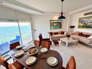a living room with a table and chairs and a couch at The bleu sea in Tunis