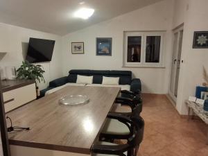 a living room with a table and a couch at Apartman Premantura Rumora in Premantura