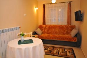 a living room with a table and a couch at Apartament U Jacka in Rabka-Zdrój
