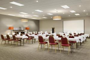 a conference room with tables and chairs and a whiteboard at Country Inn & Suites by Radisson, Sidney, NE in Sidney +32 photos