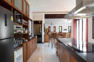 a kitchen with a counter and some chairs at Private Pool 4BR Villa with Sea View Sleeps 8 in Mae Pim