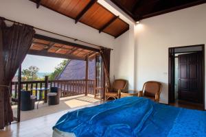 a bedroom with a bed and a balcony at Private Pool 4BR Villa with Sea View Sleeps 8 in Mae Pim