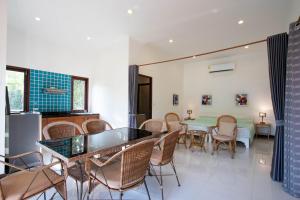 a dining room with a table and chairs at Private Pool 4BR Villa with Sea View Sleeps 8 in Mae Pim