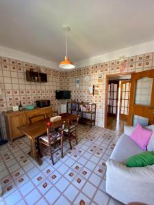 a living room with a couch and a table at Stanza matrimoniale bagno privato in Mola di Bari