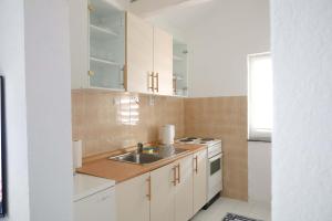 a kitchen with a sink and a stove at AG Apartmans in Gornji Vakuf