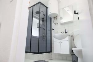 a bathroom with a shower and a sink at AG Apartmans in Gornji Vakuf +11 photos