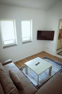 a living room with a couch and a coffee table at AG Apartmans in Gornji Vakuf
