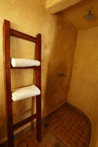 a bathroom with a ladder with towels on it at Riad Jamaï in Fez