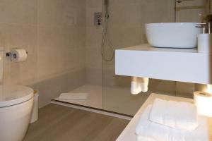 a bathroom with a shower and a toilet and towels at Hotel O'Pazo in Vigo +87 photos