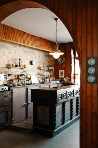 a kitchen with a stove and a counter top at Auberge du Cabestan Hotel Audierne in Audierne