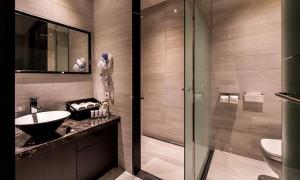 a bathroom with a sink and a glass shower at Hotel The May in Namyangju