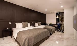 a hotel room with two beds in a room at Hotel The May in Namyangju +13 photos