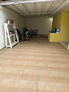 a large room with a wooden floor and a room with a yellow wall at Aloft Alvarado in Siguatepeque
