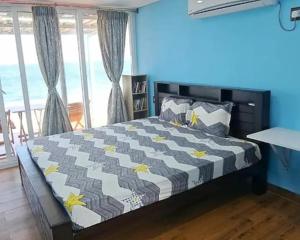 a bedroom with a bed with yellow stars on it at Sapphire Inn in Chennai