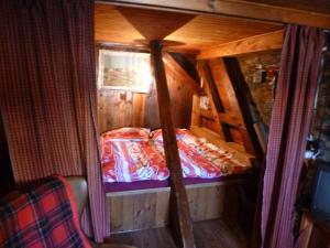a small room with a bed in a cabin at Boží Dar 96 in Boží Dar