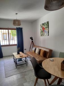 a living room with a couch and a table at Casa sol y mar in Vera