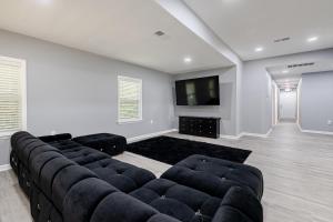 a living room with a couch and a flat screen tv at Large 3 bed 2 bath home in Mobile