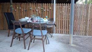 a table with chairs and plates on top of it at Truck Caravan Rustic Sunflower in Mount Crosby +10 photos