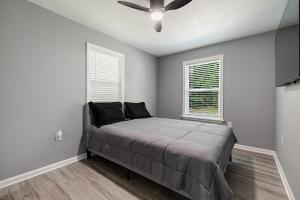 a bedroom with a bed and a ceiling fan at Large 3 bed 2 bath home in Mobile
