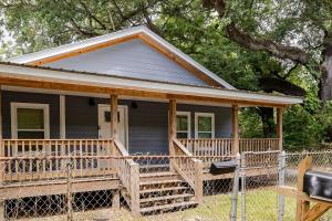 a small gray house with a porch and a porch at Large 3 bed 2 bath home in Mobile