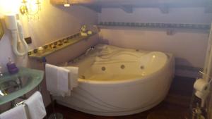 a bathroom with a white tub and a sink at B&B Vittoria Colonna in Marino