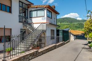 a white house with stairs and a fence at Guest House Fantaccini con Piscina in Pelago