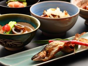 a plate of food with bowls of food on a table at Nagataki in Nakatsugawa