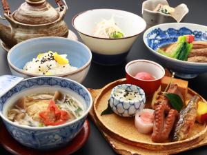 a table with bowls and plates of food on it at Nagataki in Nakatsugawa