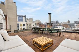 a patio with a table and chairs on a roof at Maison Lombard by Reside in Brussels
