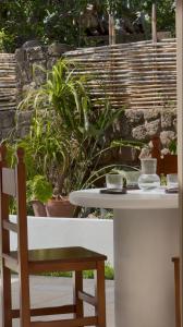 a white table with a chair and some plants at Casa Olivi in Ventotene
