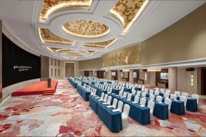 a large room with rows of chairs on a carpet at Pullman Beijing South - Newly Renovated in Beijing +175 photos